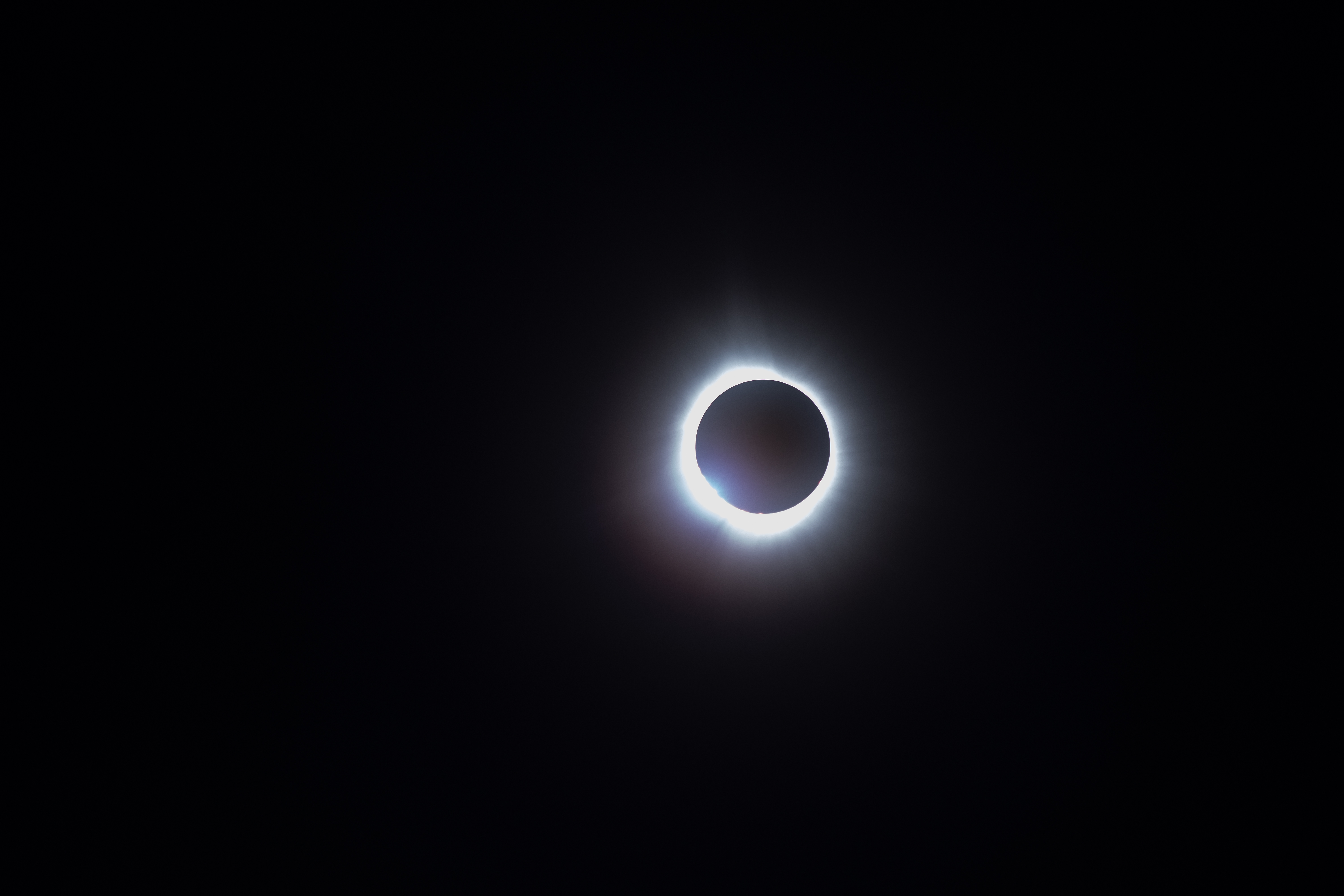 The sun during totality, showing a hint of the 'diamond ring' effect on the left side